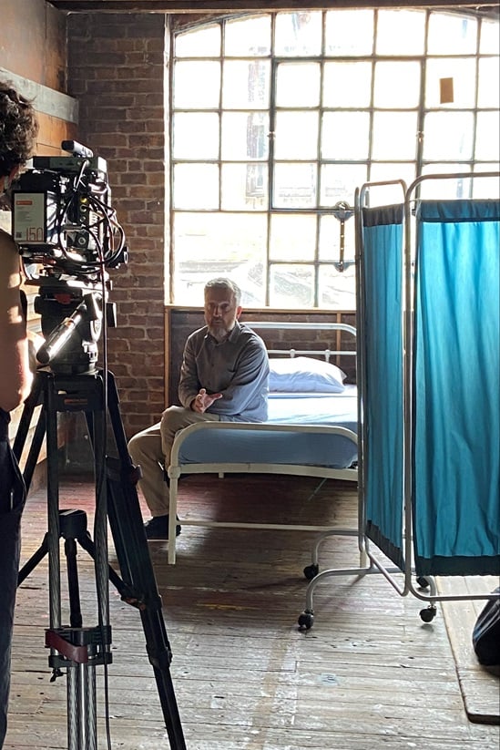 Director of Photography, Emily Almond Barr lines up a shot with actor Jonathan McGuinness